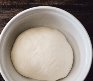 Homemade white bread dough, in a greased bowl, rising until doubled in size