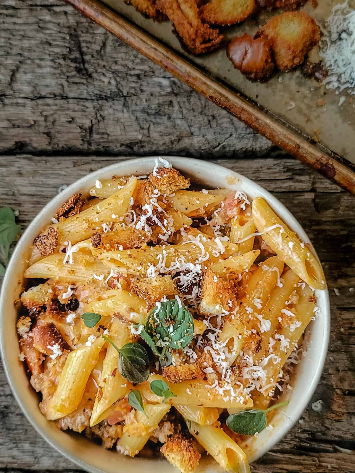 Penne pasta in a tomato cream sauce with sausage, cheese and croutons.