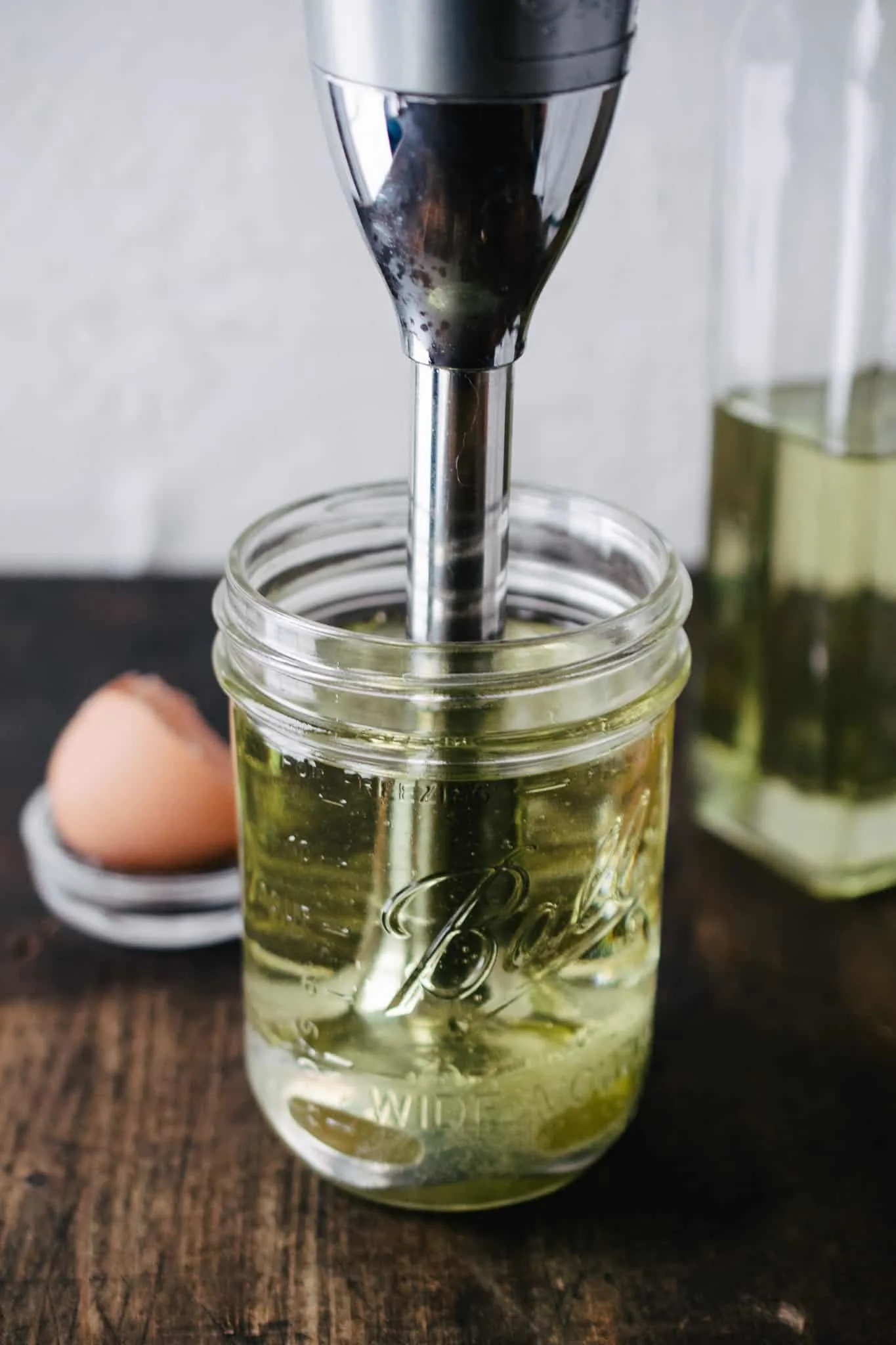 immersion blender in a jar of oil, lemon juice and egg yolk to make mayonnaise
