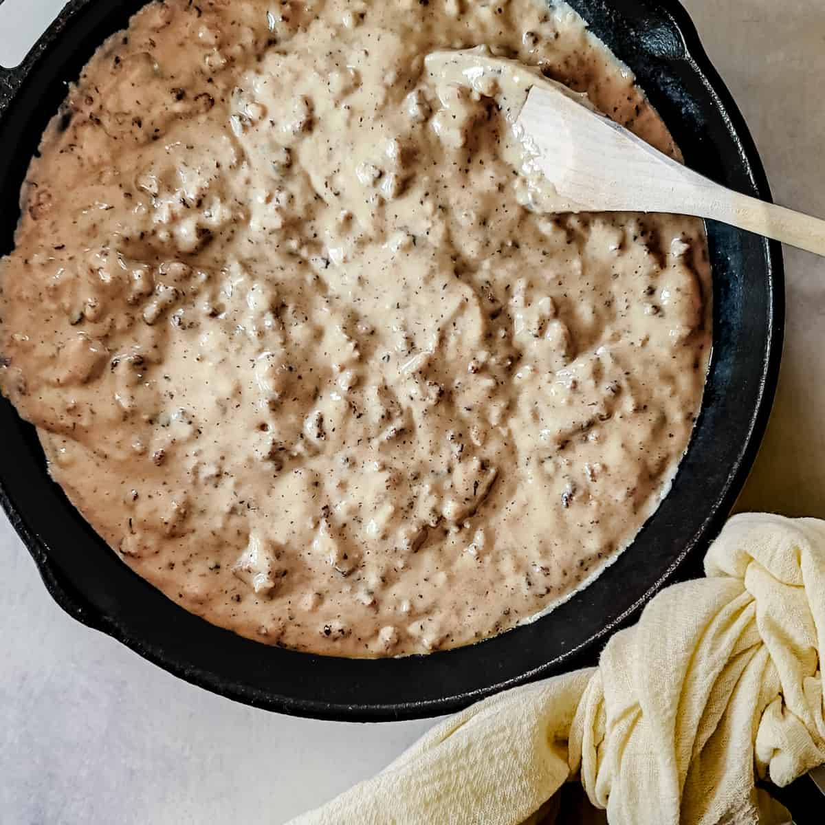 Country sausage gravy in a cast iron skillet. 