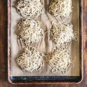 Piles of alkaline ramen noodles on parchment paper.