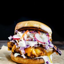 crispy fried chicken sandwich with melted cheese and carrot radish slaw