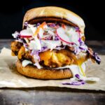 crispy fried chicken sandwich with melted cheese and carrot radish slaw