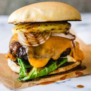 beef patty basted in pineapple teriyaki sauce topped with grilled pineapple, lettuce, onion and spicy mayo on a Hawaiian bun