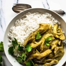 A bowl of creamy coconut chicken curry served with rice.