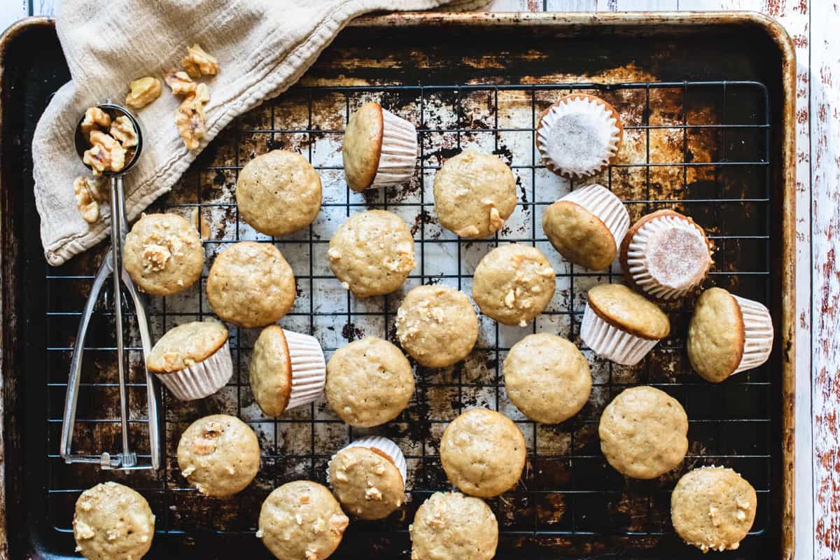 Mini banana muffins on a wire cooling rack.