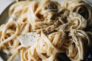 close up of creamy homemade authentic fettuccine alfredo with chicken