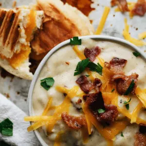 Beer cheese and potato bacon soup with grilled cheese panini and crumbled bacon