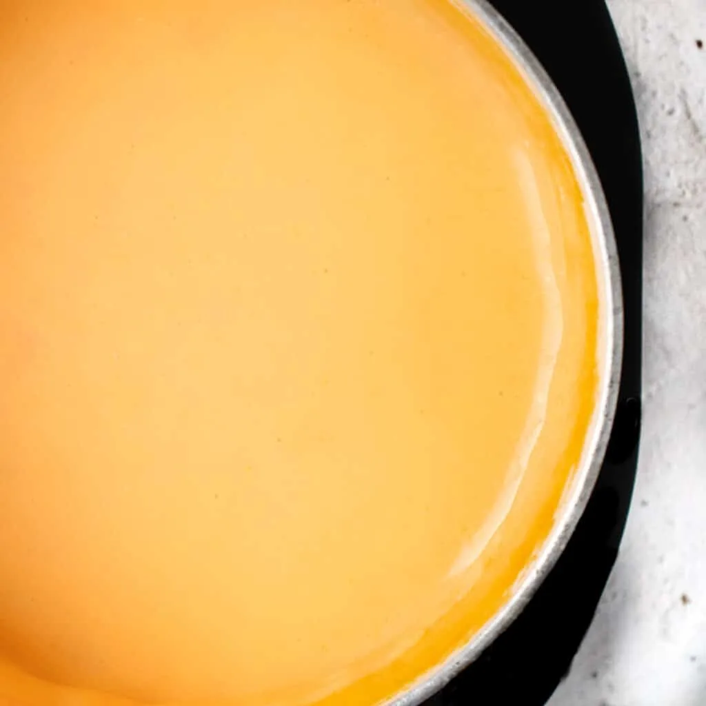 Melted cheese sauce in a sauce pan. 