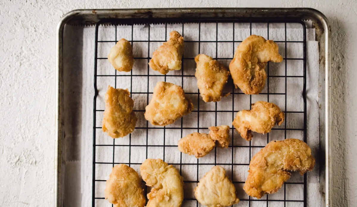 Wire rack for deep fried, breaded chicken pieces.