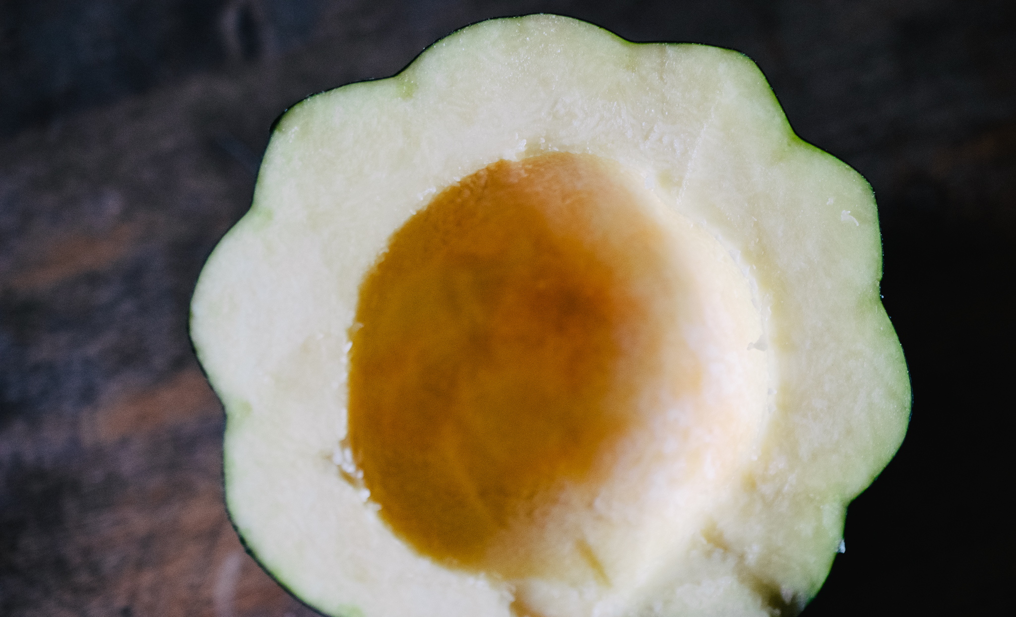 DSC_0137 acorn squash cut in half and seeds scooped out on wooden cutting board