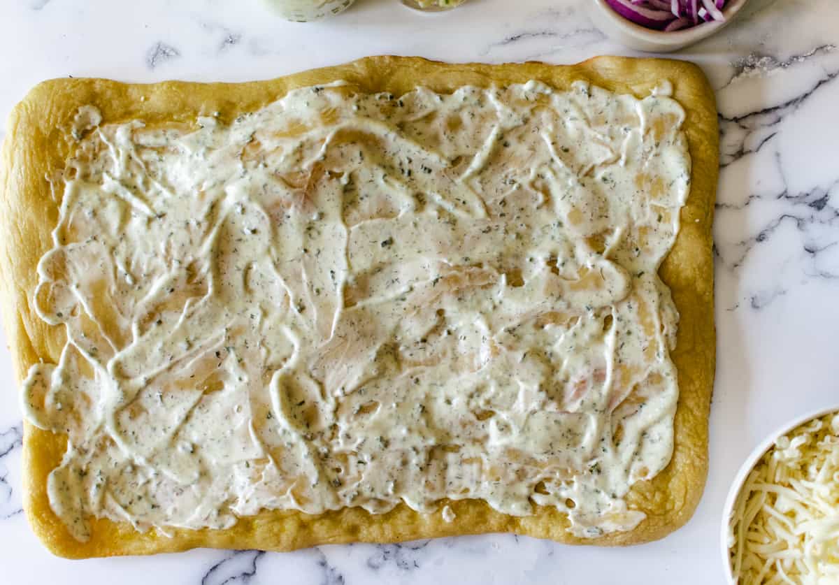 rectangular pizza crust with ranch sauce