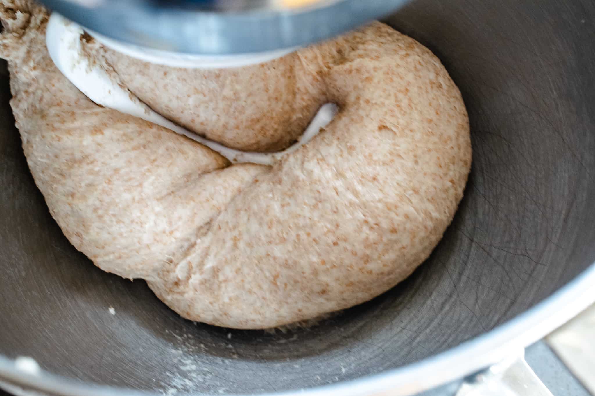 mixer and dough hook kneading whole wheat dough for sandwich bread