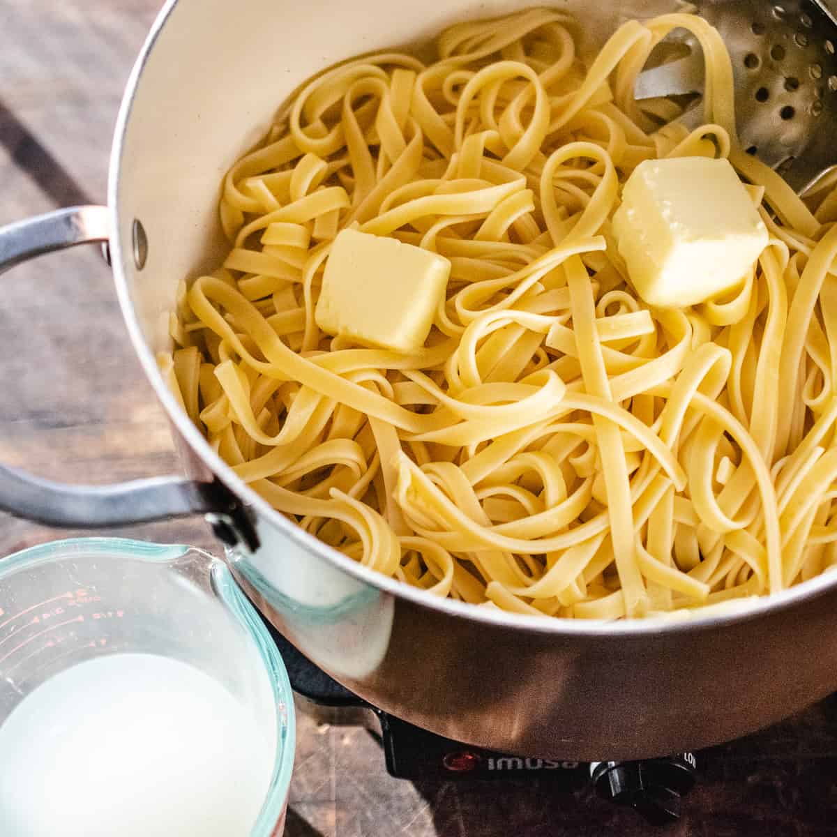 Buttered noodles in a pot.