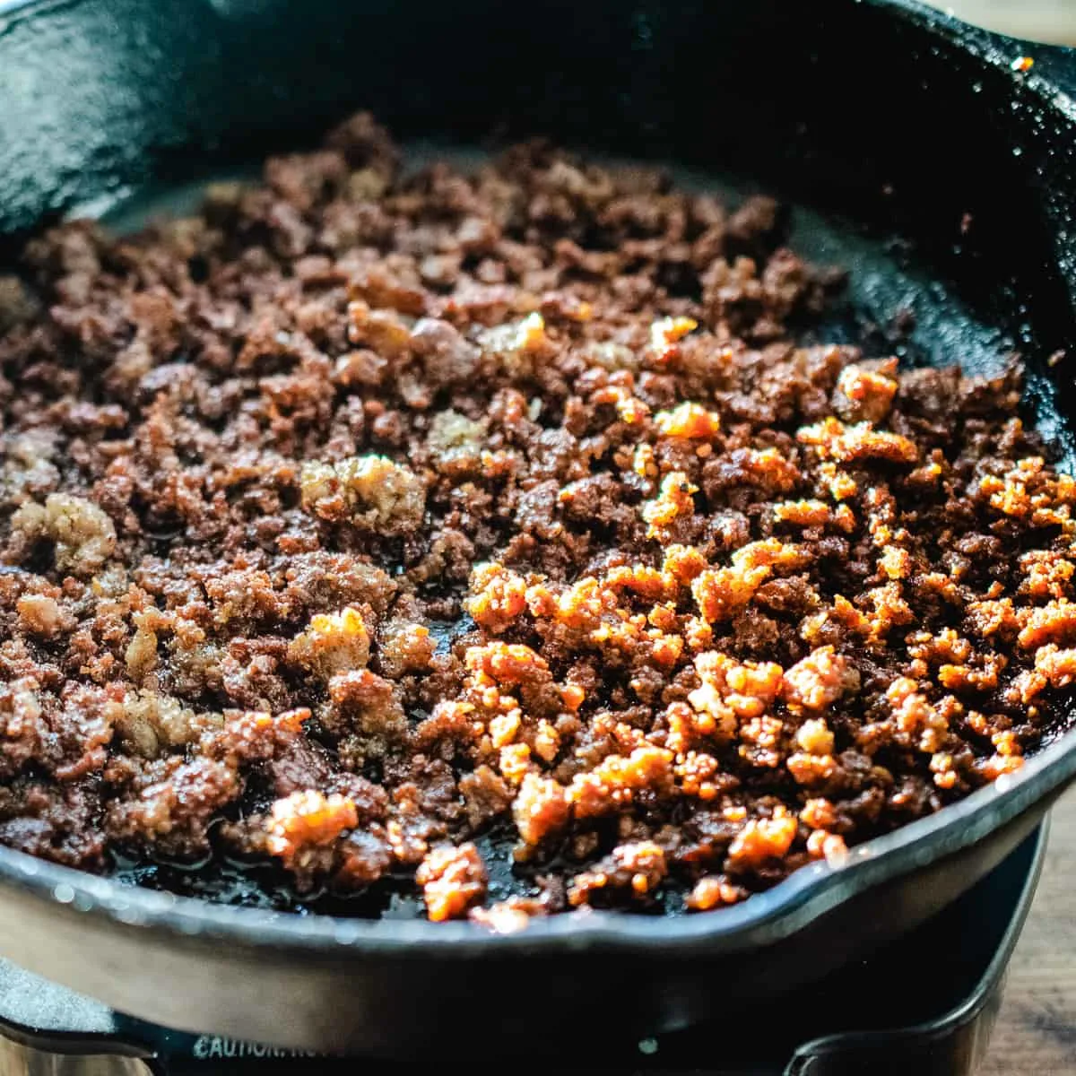 Sausage frying in a skillet.