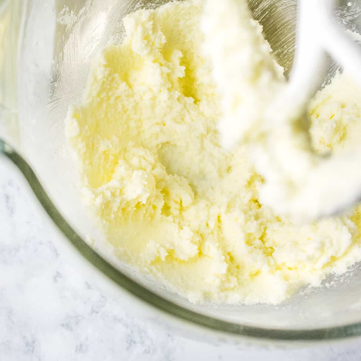 Butter, sugar and vanilla extract creamed together in a mixing bowl. 