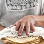 woman holding a stack of homemade soft flour tortillas