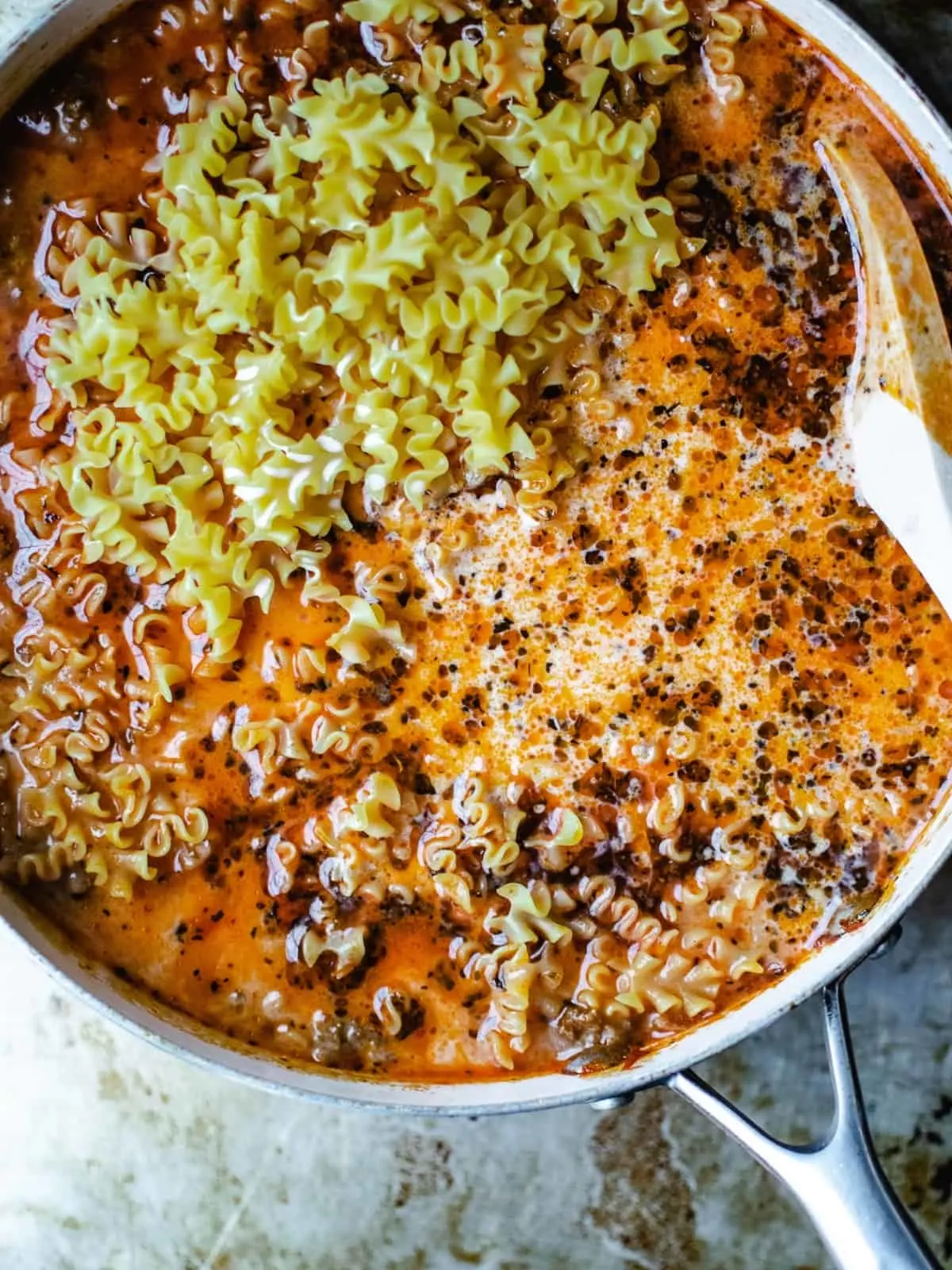 Mafalda pasta in a tomato sauce in a skillet.