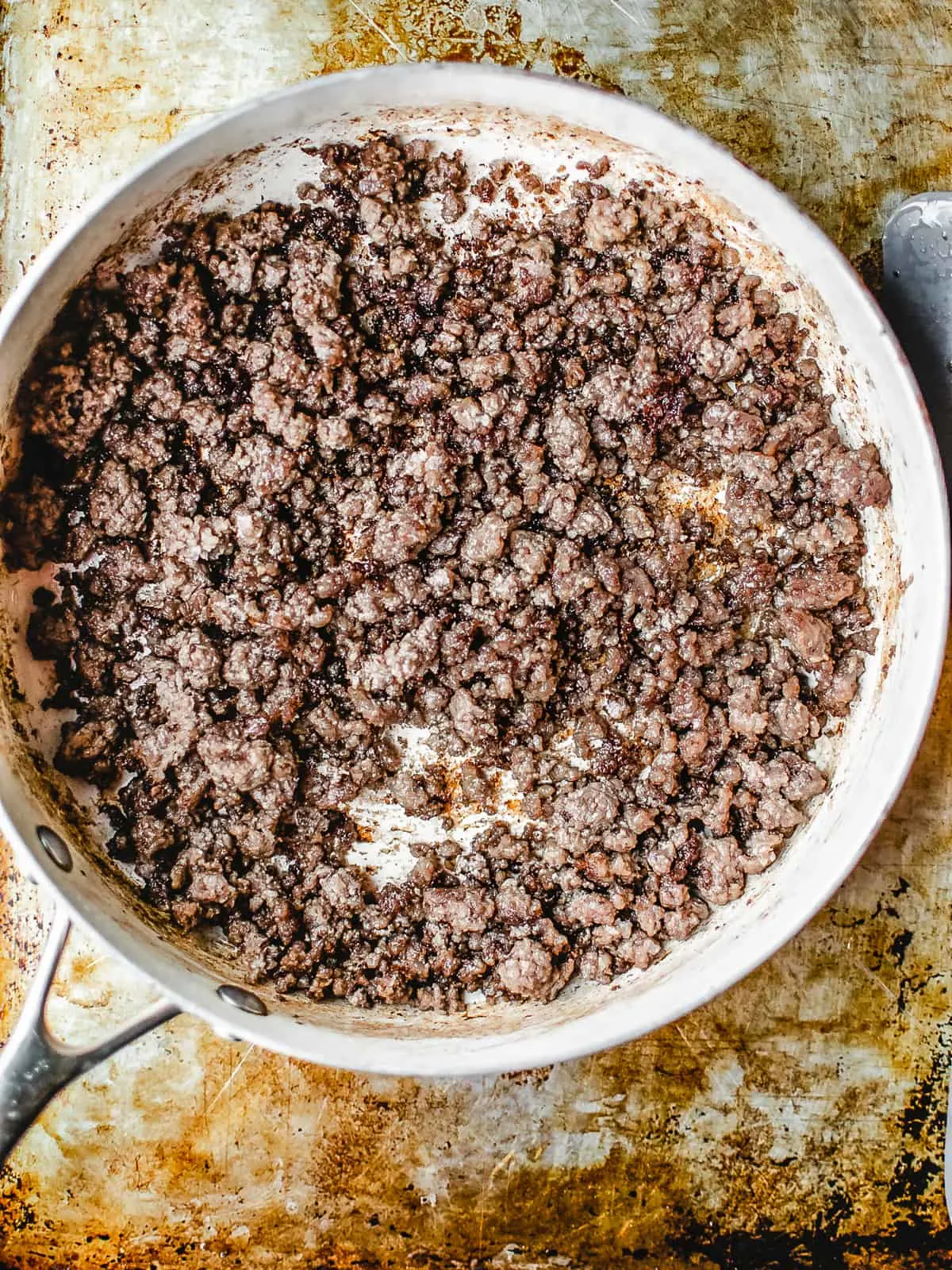 Ground beef browning in a skillet