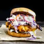 Crispy fried chicken sandwich with melted cheese and carrot radish slaw