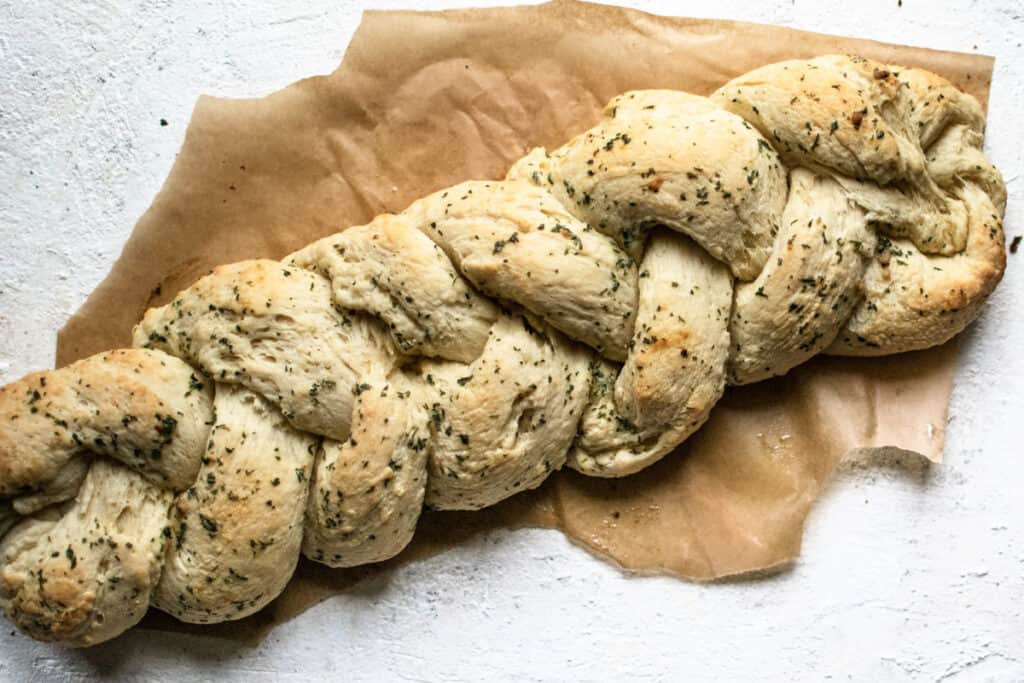 baked loaf of garlic bread shaped into a braid