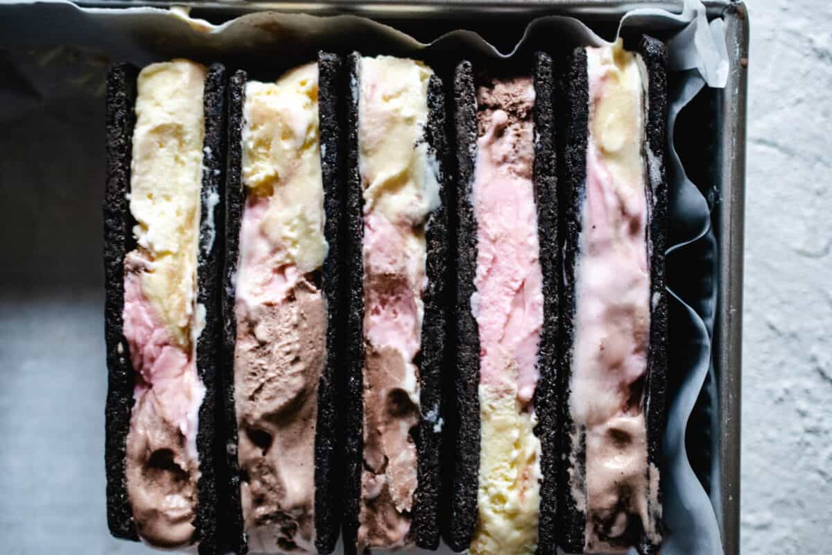 chocolate rectangle cookies filled with Neapolitan ice cream in metal box