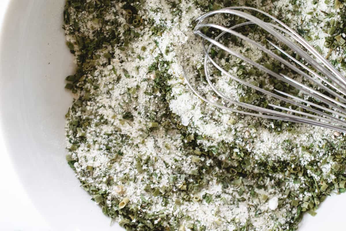 herbs and spices and buttermilk powder whisked together in a bowl.