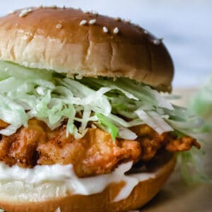 fried chicken patty, mayonnaise, and shredded lettuce on a poppy seed bun