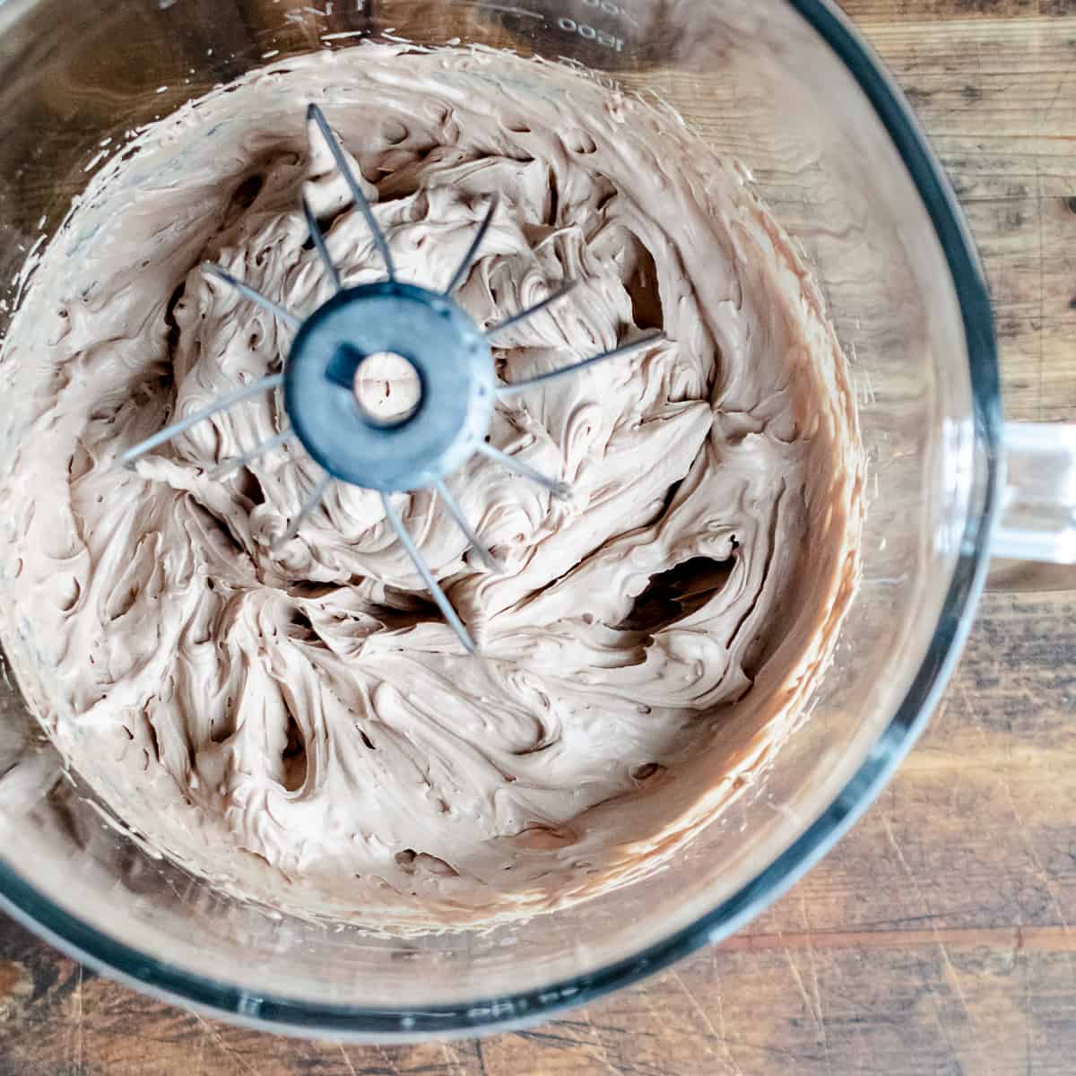 Whipped chocolate frosting in a mixing bowl. 