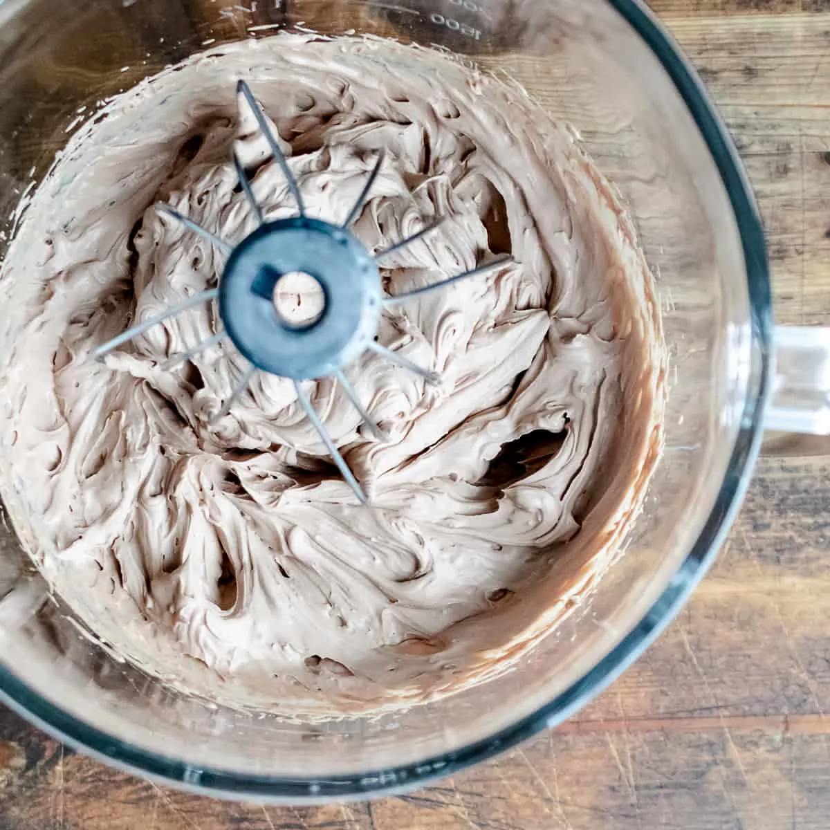 Whipped chocolate frosting in a mixing bowl. 