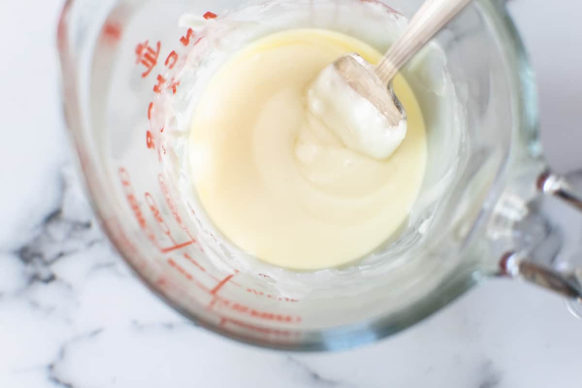 melted white chocolate in a glass measuring cup