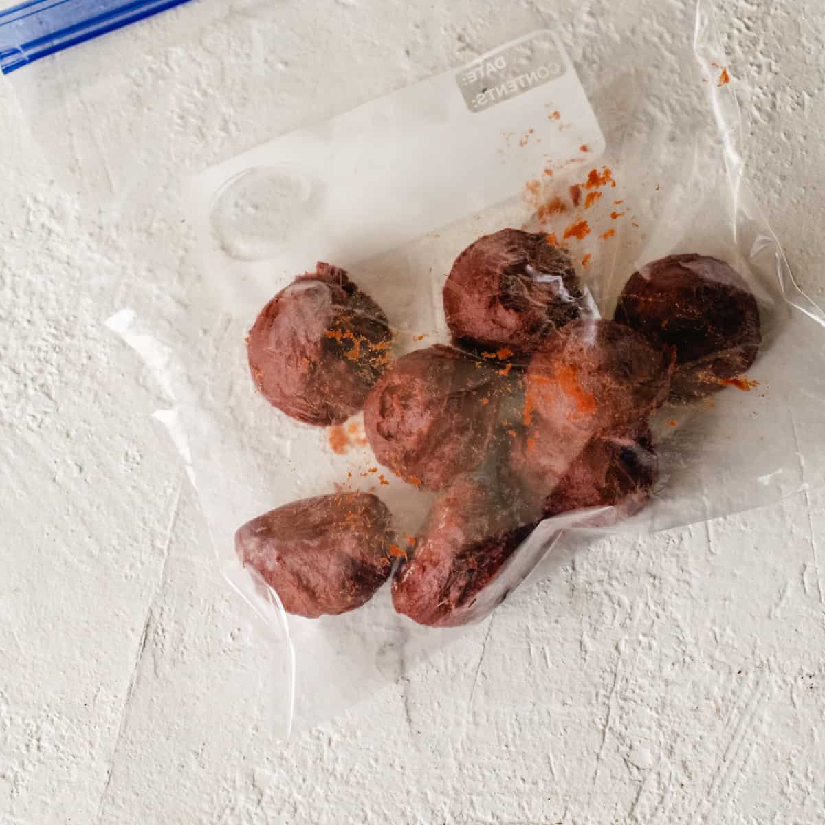 A plastic bag filled with frozen balls of tomato paste.