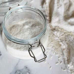Glass mason jar filled with ground rice grains.
