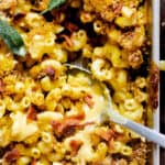 Casserole dish with macaroni, cheese, bacon and herbs.