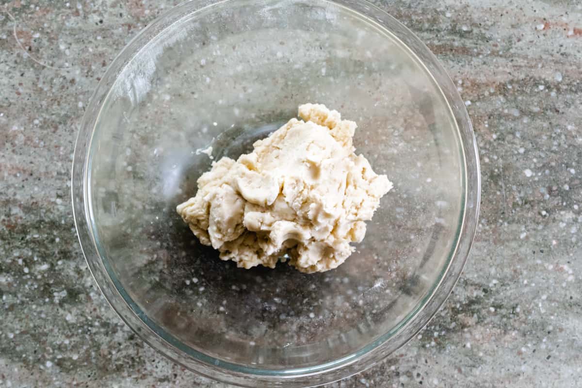 Pie crust dough in a glass bowl.