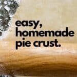 Pie crust dough rolled out by a rolling pin.