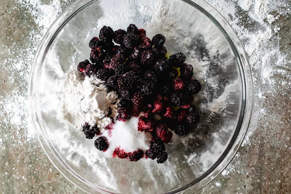 Blackberry and raspberry pie filling in a glass bowl.