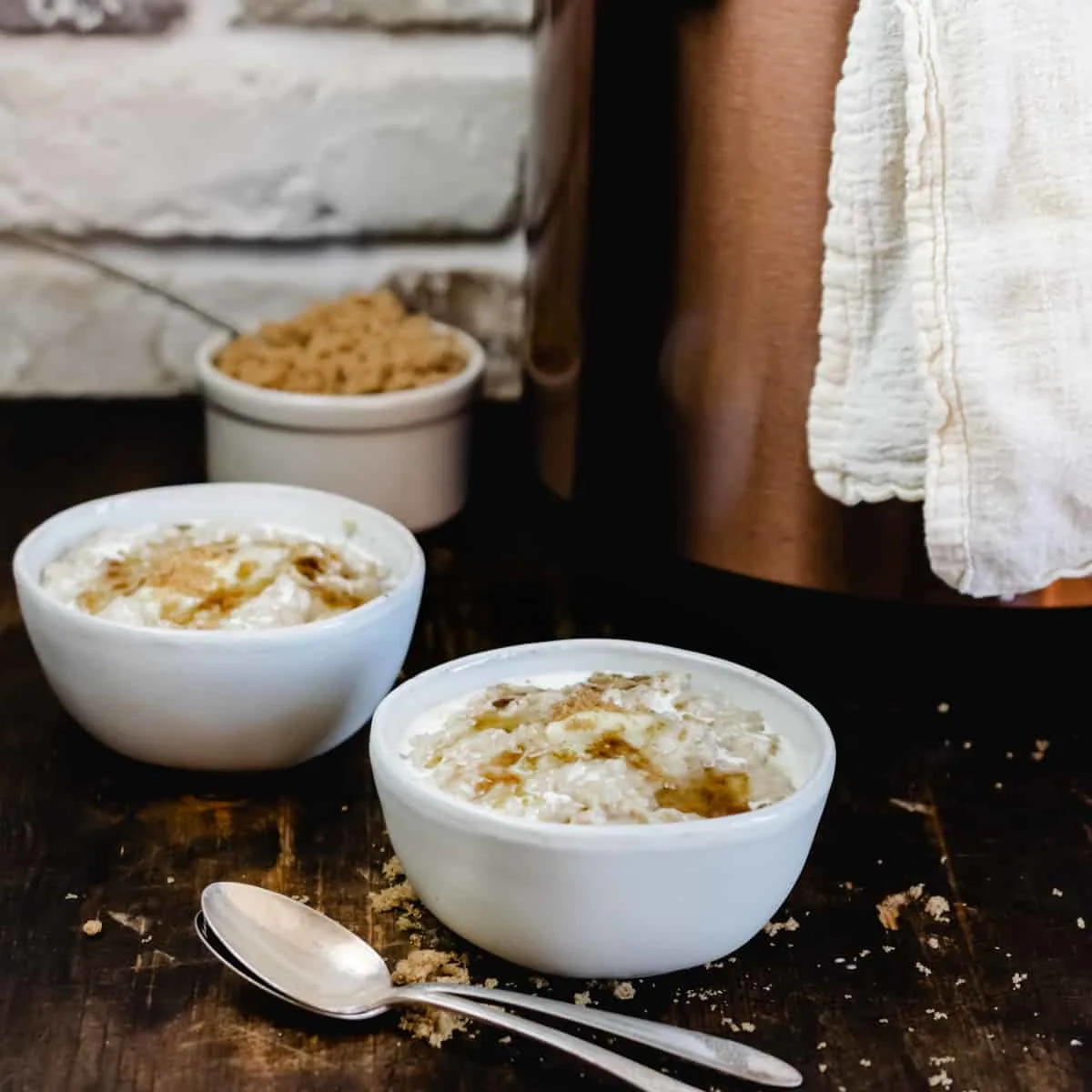 Bowls of oatmeal in front of a pressure cooker. 