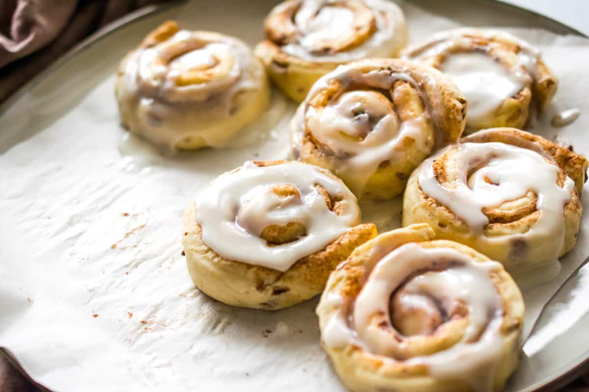 Cinnamon rolls with icing on a plate.
