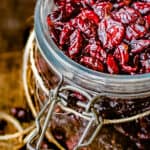 A glass jar of dried cranberries.