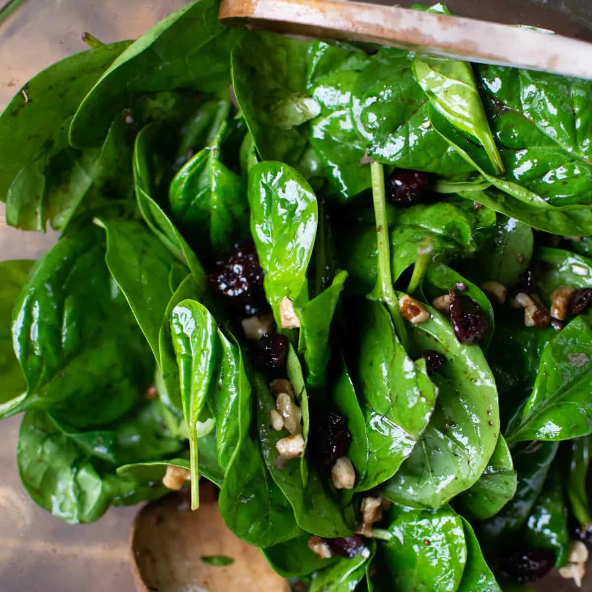 Baby spinach leaves covered in a light dressing.