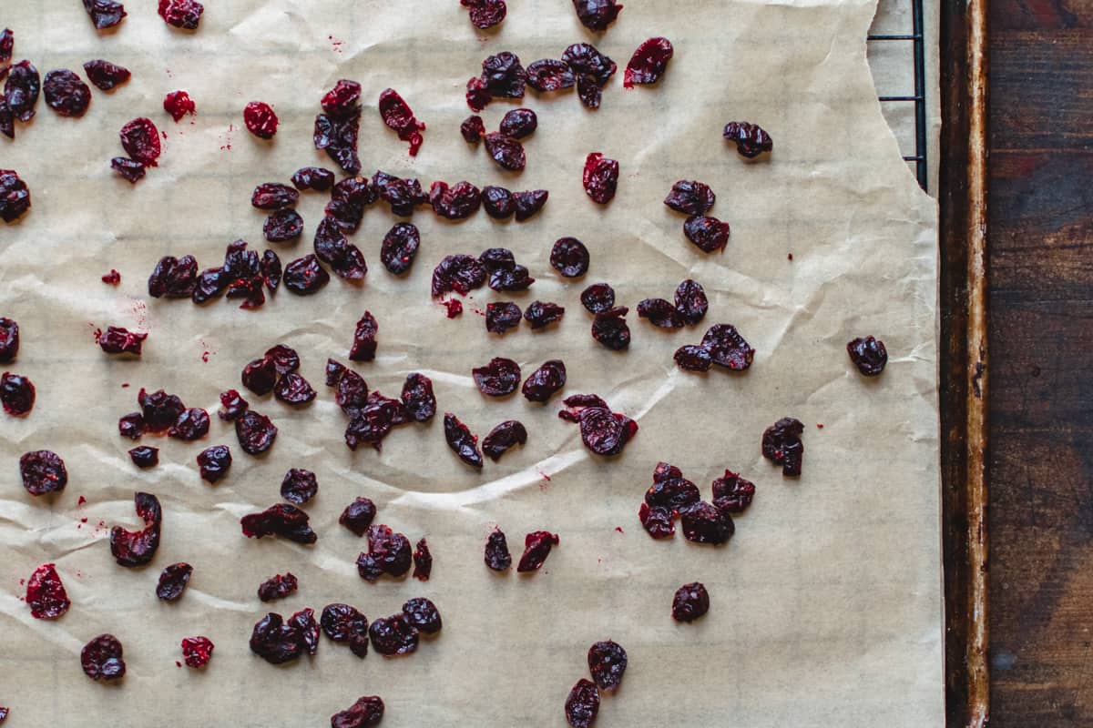 Dried cranberries on a baking rack.