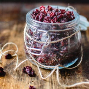 Jar of dehydrated cranberries with jute string tied around it.