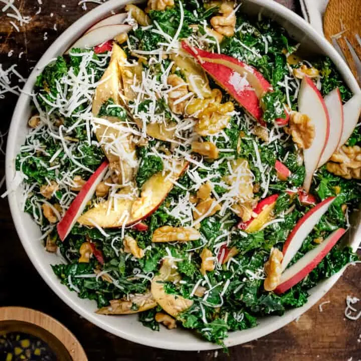 Tossed kale salad with apples and walnuts.