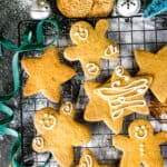 Gingerbread cookies decorated with icing on a cooling rack.