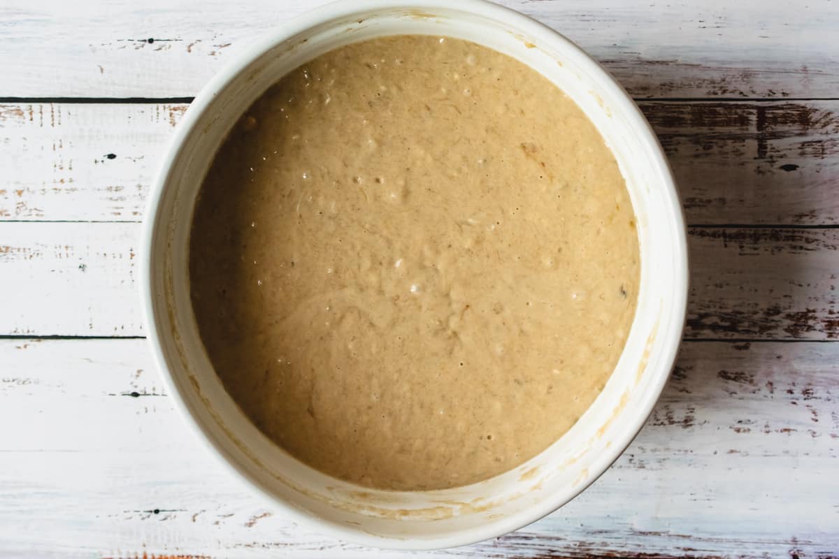 A large mixing bowl filled with banana muffin batter.