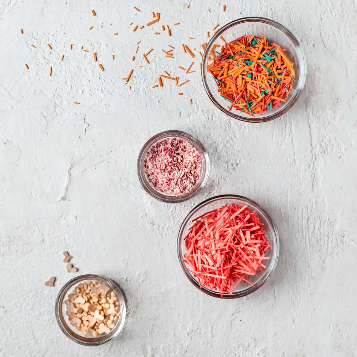 Glass bowls filled with different shaped, sized and colored sprinkles.