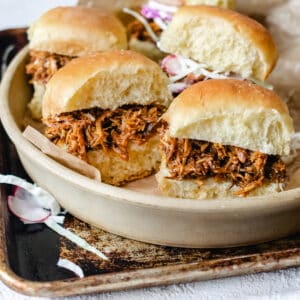 Shredded pork in a barbecue sauce on mini buns with coleslaw on the side.