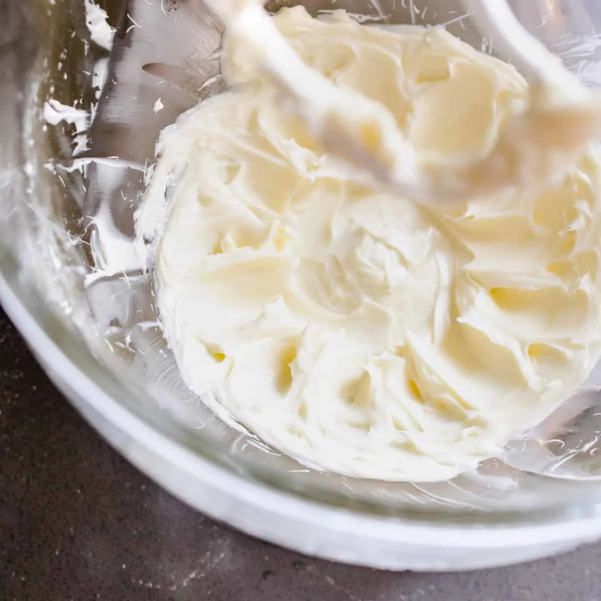 Butter and sugar beaten in a glass mixing bowl. 