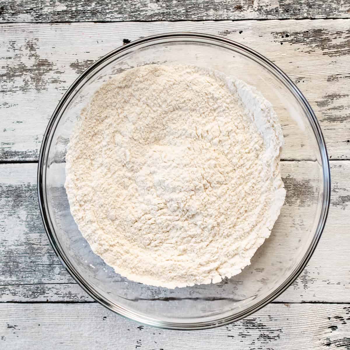 Flour, salt and baking powder whisked in a glass bowl.